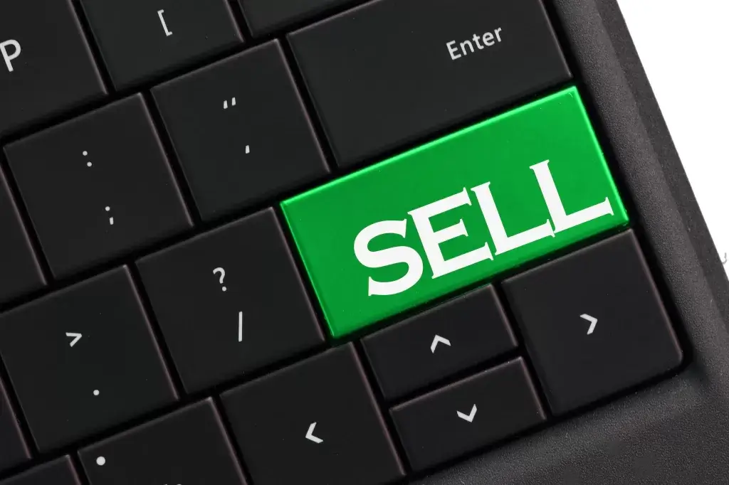 Sell - computer keyboard with green SELL button. Selling online concept